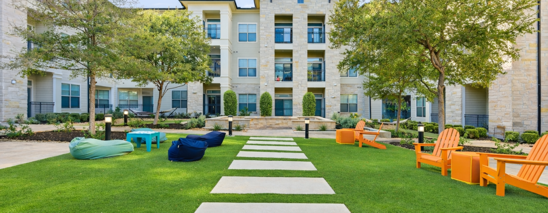 a spacious courtyard with a lawn and sitting area
